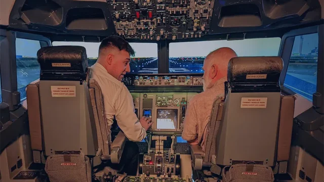 Inside the uPilot Boeing 737 flight simulator cockpit in Dublin showing the captain's seat and flight controls.